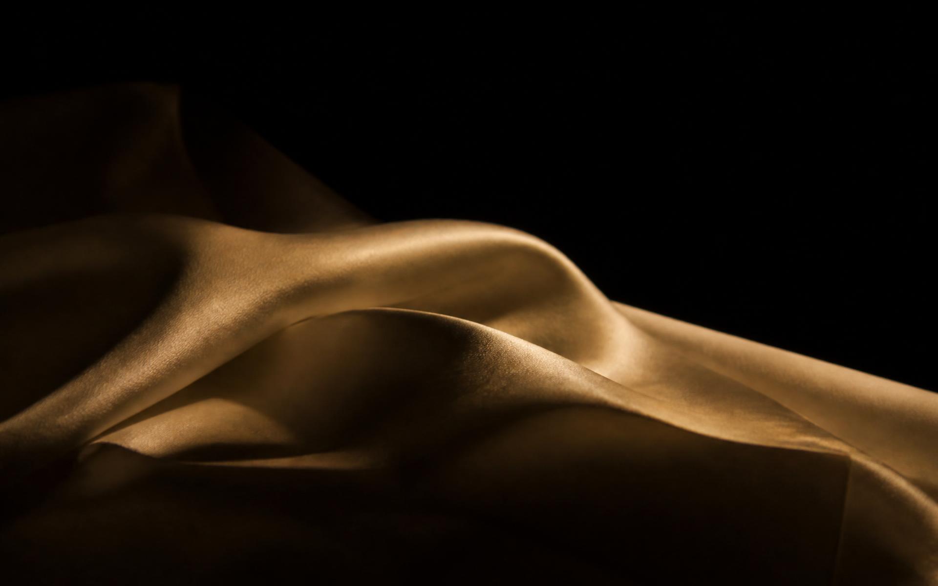 Warm ivory silk lit by a single champagne-gold light